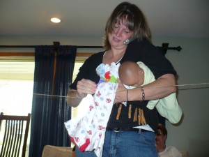 The baby doesn't look so comfortable... but the clothes pins on the shirt is very creative!